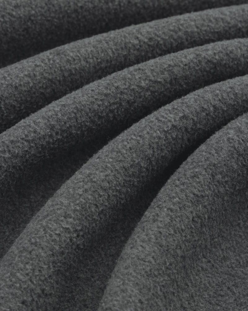 Close-up of soft Melange Fleece Shirt fabric in dark gray, highlighting its visible texture and gentle folds.