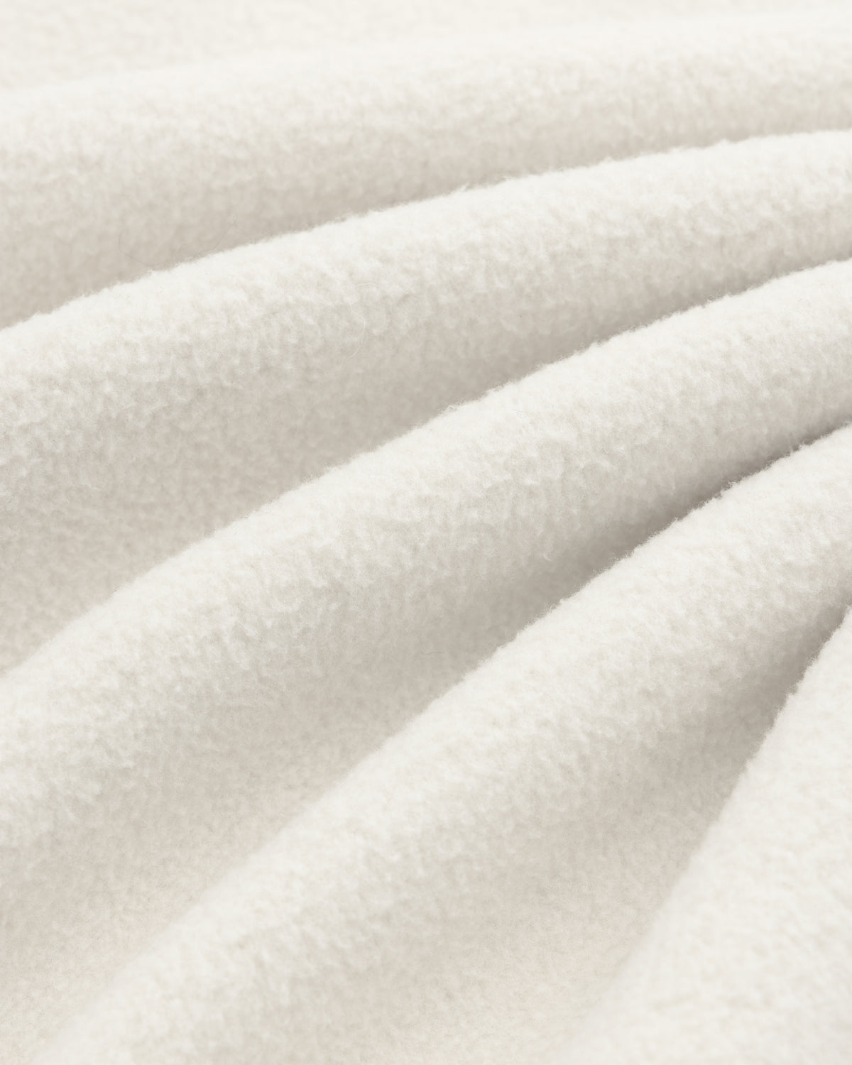 Close-up of the Melange Fleece Shirt in cream, showing its soft texture, cozy surface, and gentle fabric folds.