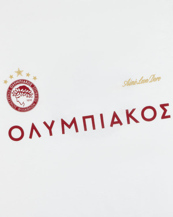 ALD / Olympiacos F.C. Souvenir Tee in white featuring the team crest, Greek lettering, and a small gold script logo.