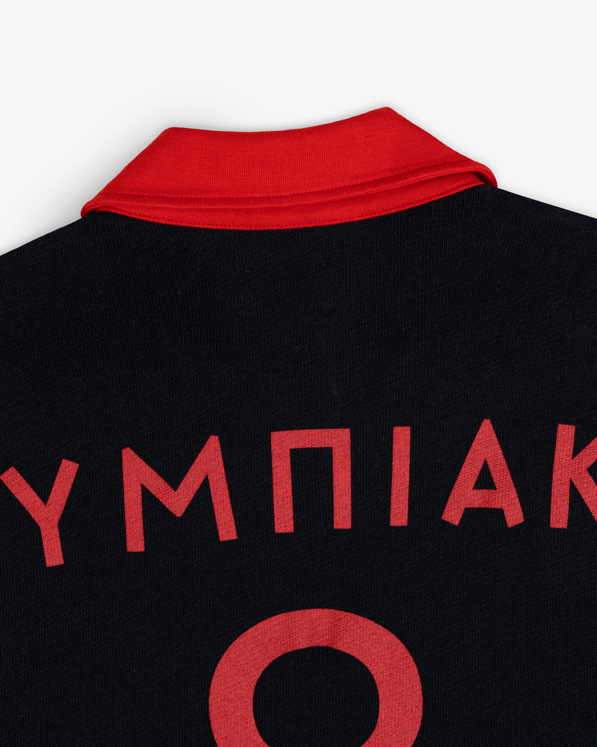 ALD / Olympiacos F.C. Heritage Ringer Polo: black shirt with a red collar, red Greek lettering, and a large zero on the back.