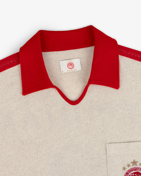 Cream-colored ALD / Olympiacos F.C. Heritage Ringer Polo with a red collar, red knit shoulders, and a team chest crest.