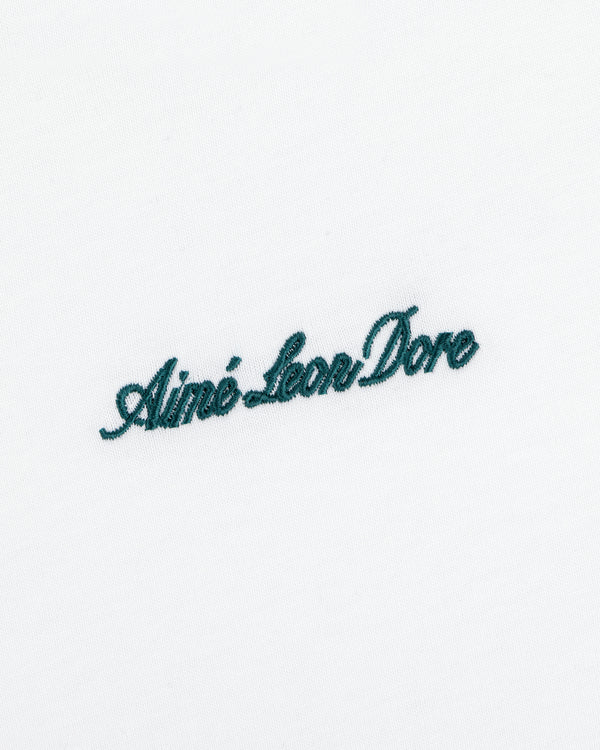 White Shrunken Script Tee with Aimé Leon Dore embroidered in dark green cursive script.