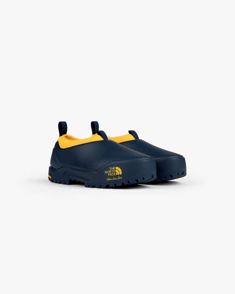 ALD / The North Face Base Camp Mule in navy with yellow lining and logo, shown on a plain white background.