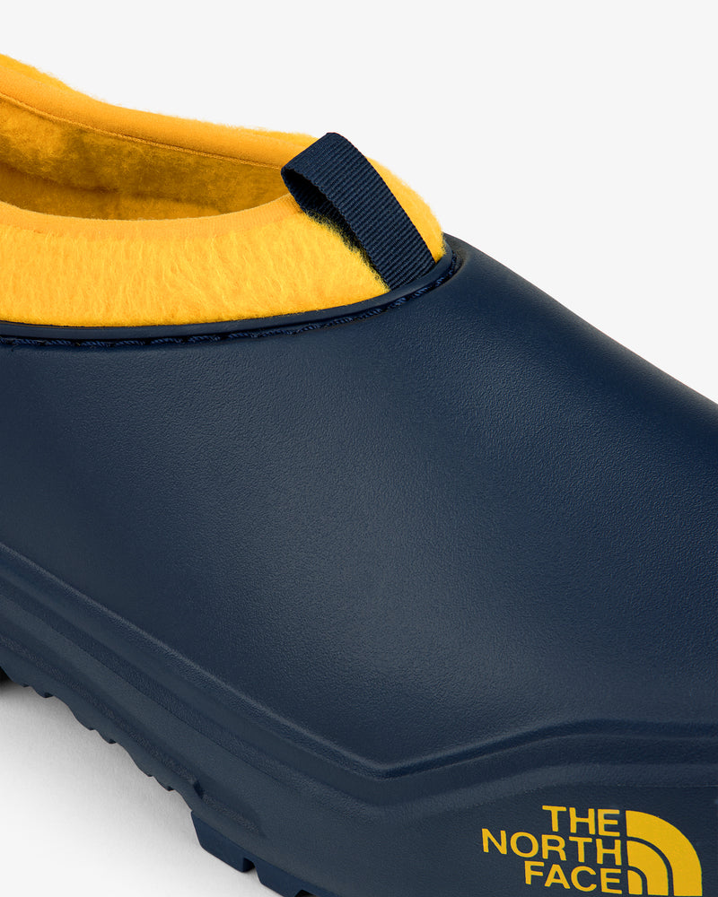 Close-up of a navy and yellow ALD / The North Face Base Camp Mule with logo on the side.