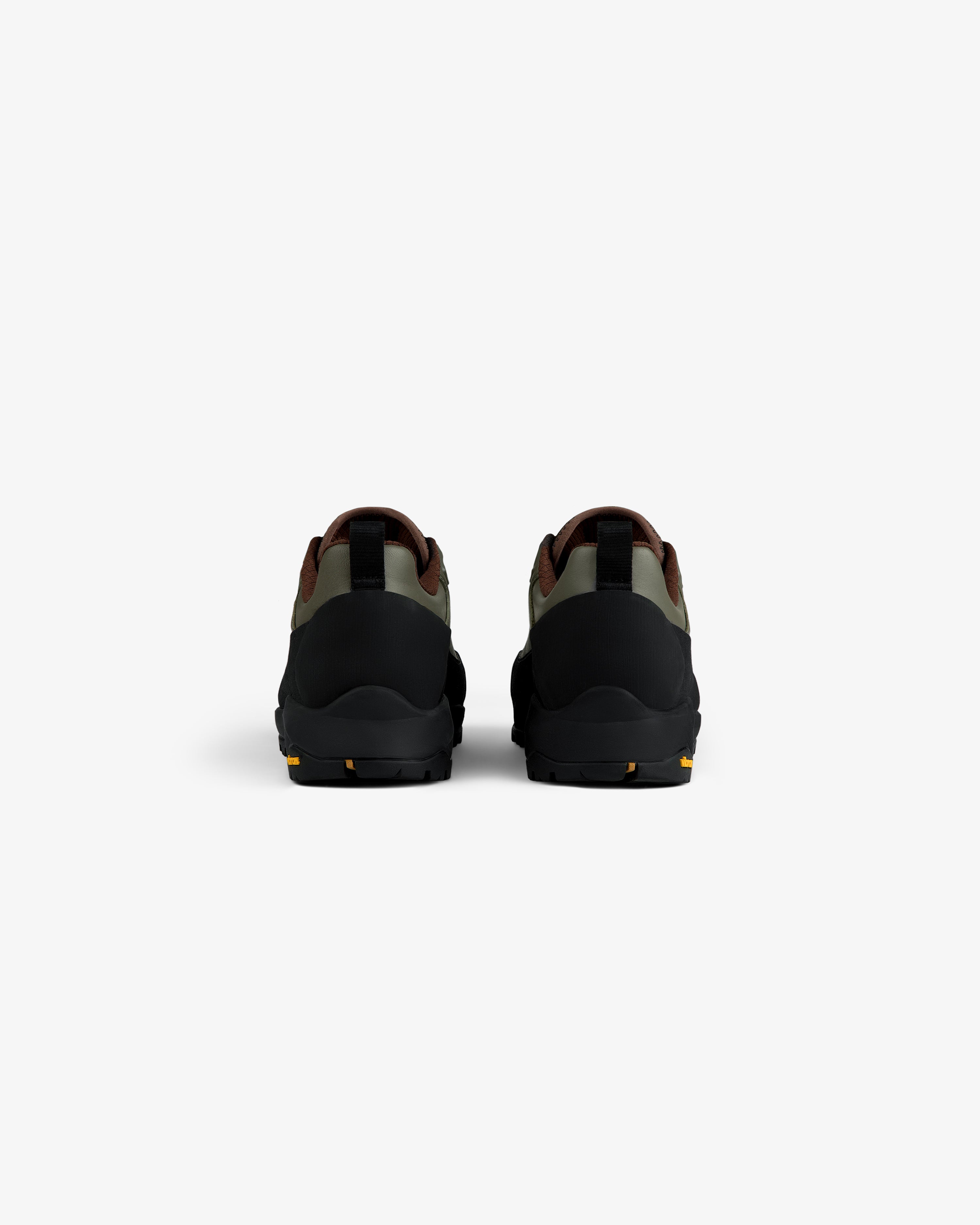 Back view of ALD/The North Face Verto Alpine GORE-TEX Hiking Shoes in black, green & brown on white background.