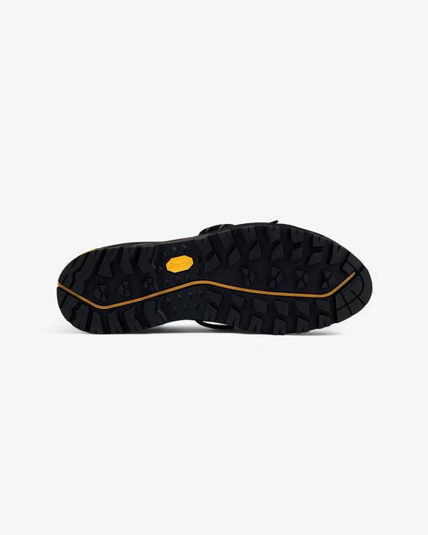 ALD/The North Face Verto Alpine GORE-TEX shoe sole, rugged black tread, viewed from the bottom on white background.
