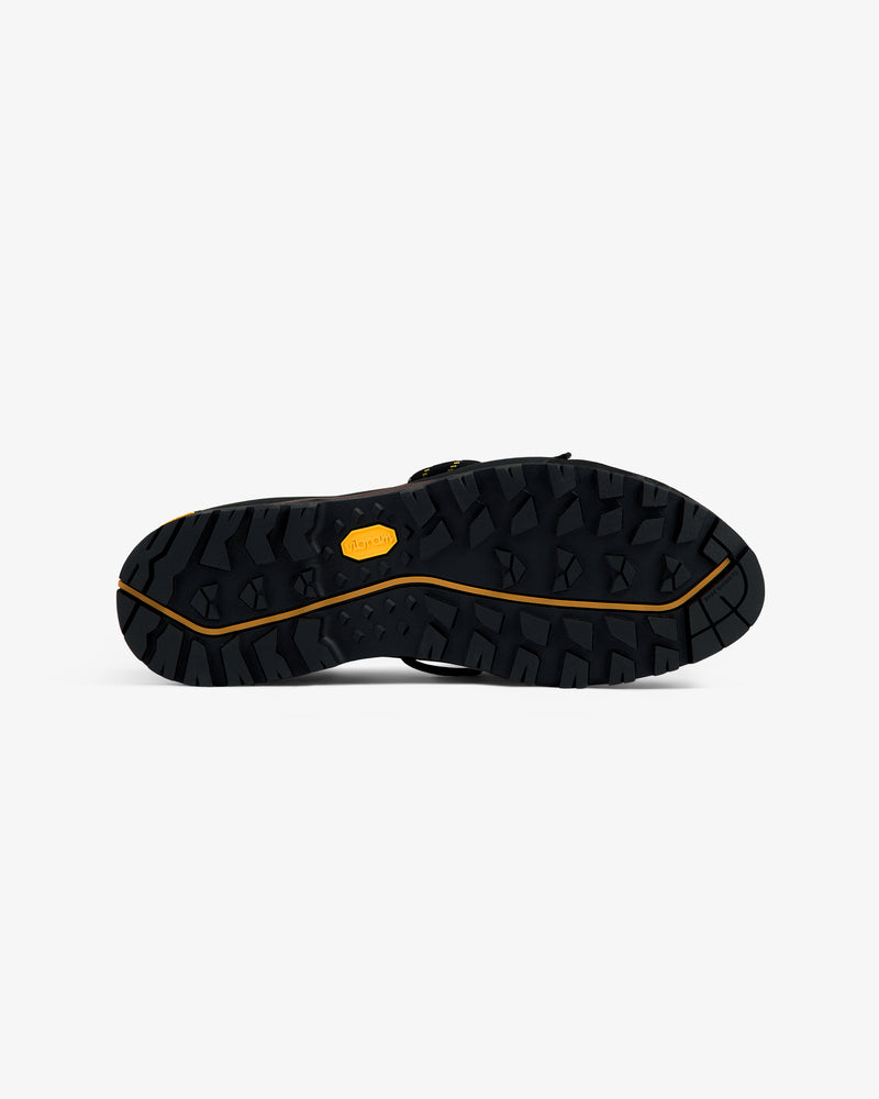ALD/The North Face Verto Alpine GORE-TEX shoe sole, rugged black tread, viewed from the bottom on white background.