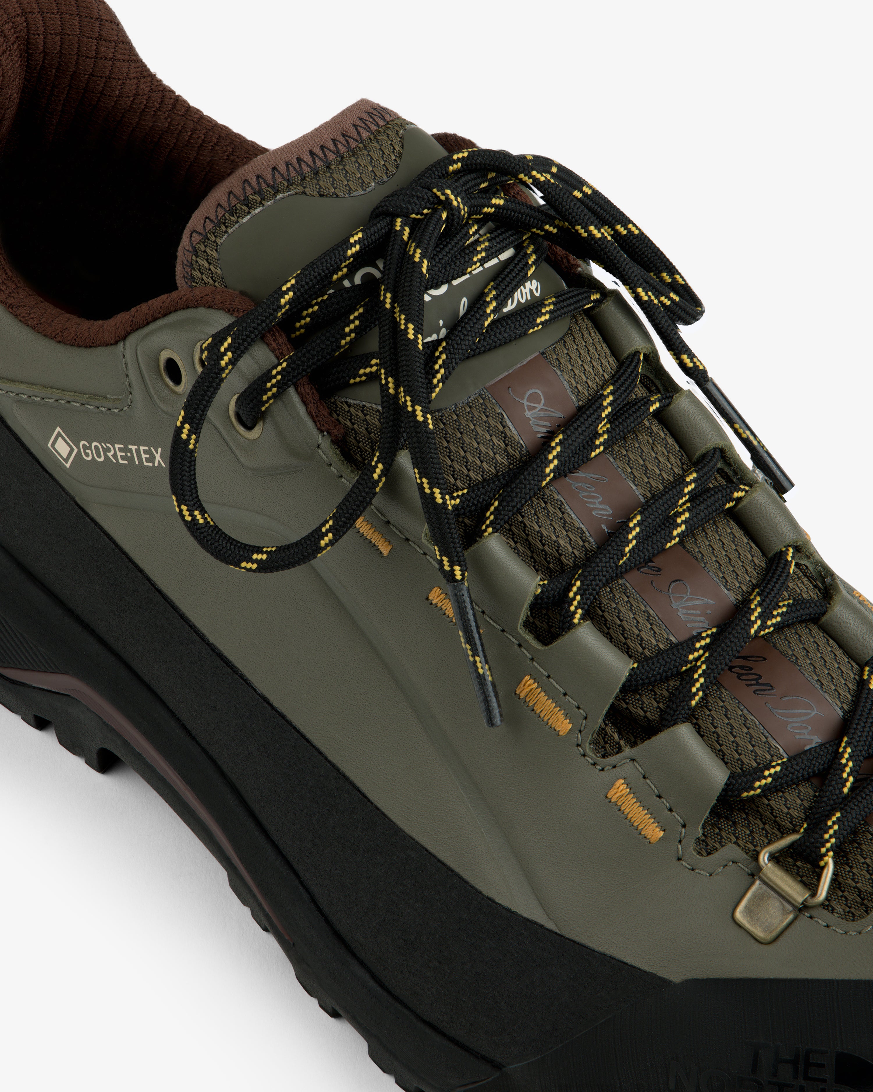 ALD/The North Face Verto Alpine GORE-TEX hiking shoe in olive green with black-yellow laces, brown accents, top view.