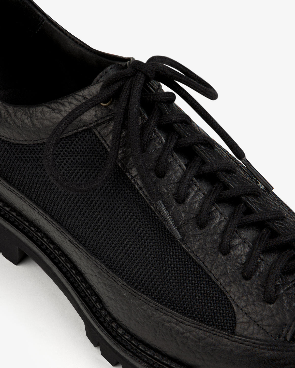 Field Boot in black, featuring a textured leather and mesh upper with a lace-up design and a lugged sole.