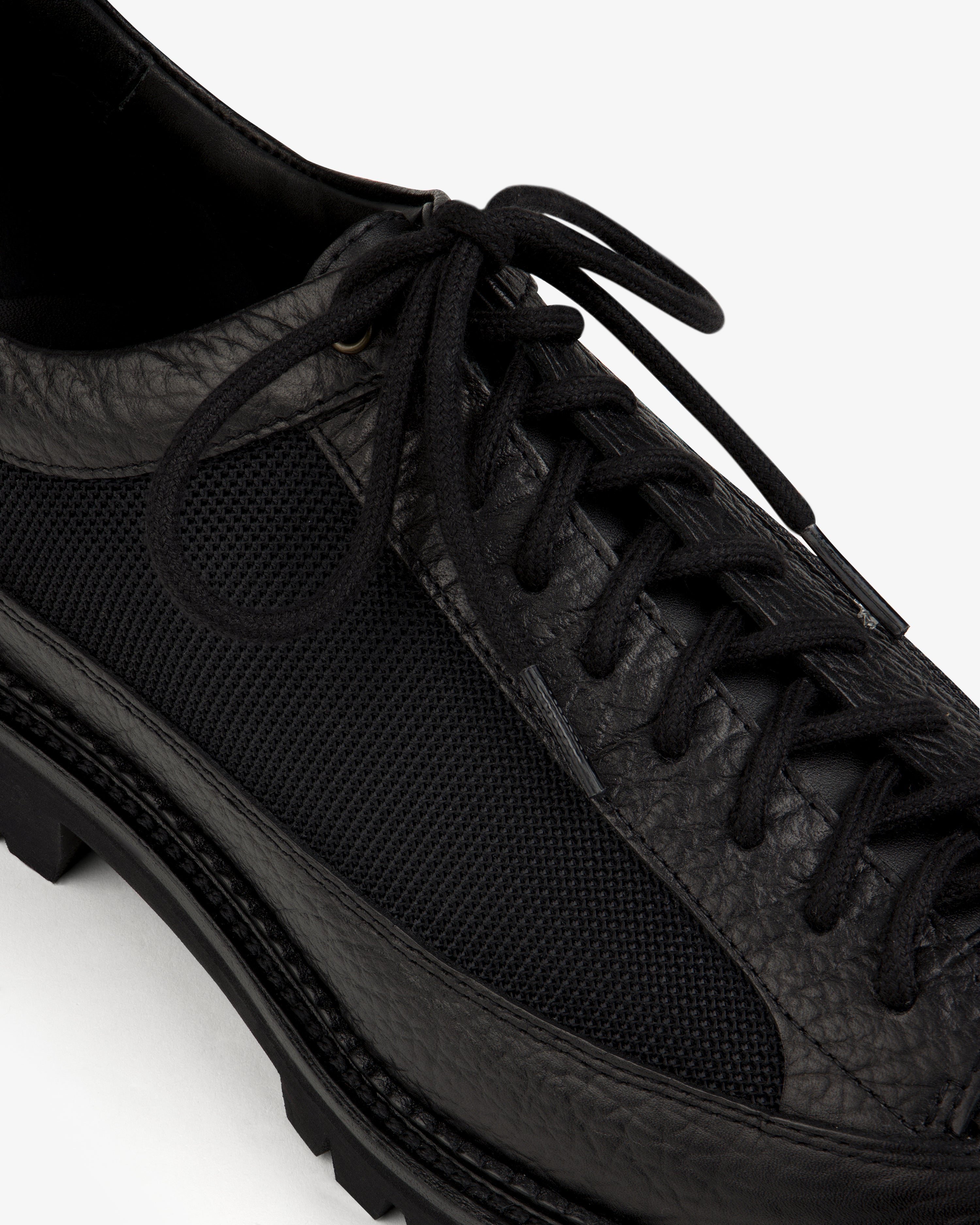 Field Boot in black, featuring a textured leather and mesh upper with a lace-up design and a lugged sole.