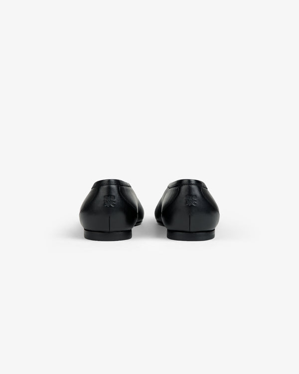 Back view of two black Leather Ballet Flats with a small embossed logo on the heels.