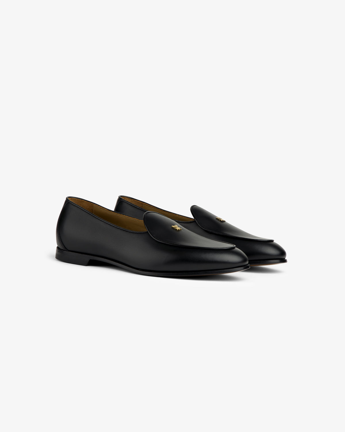 Crest Salóni Loafer: Black leather loafers with a gold bee detail, displayed on a white background.