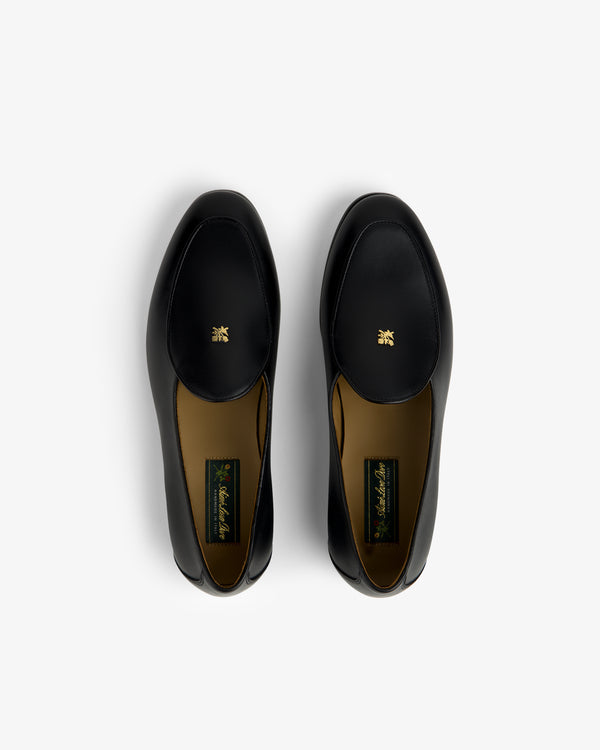 Crest Salóni Loafer: black leather pair with gold emblem, top view on a plain white background.