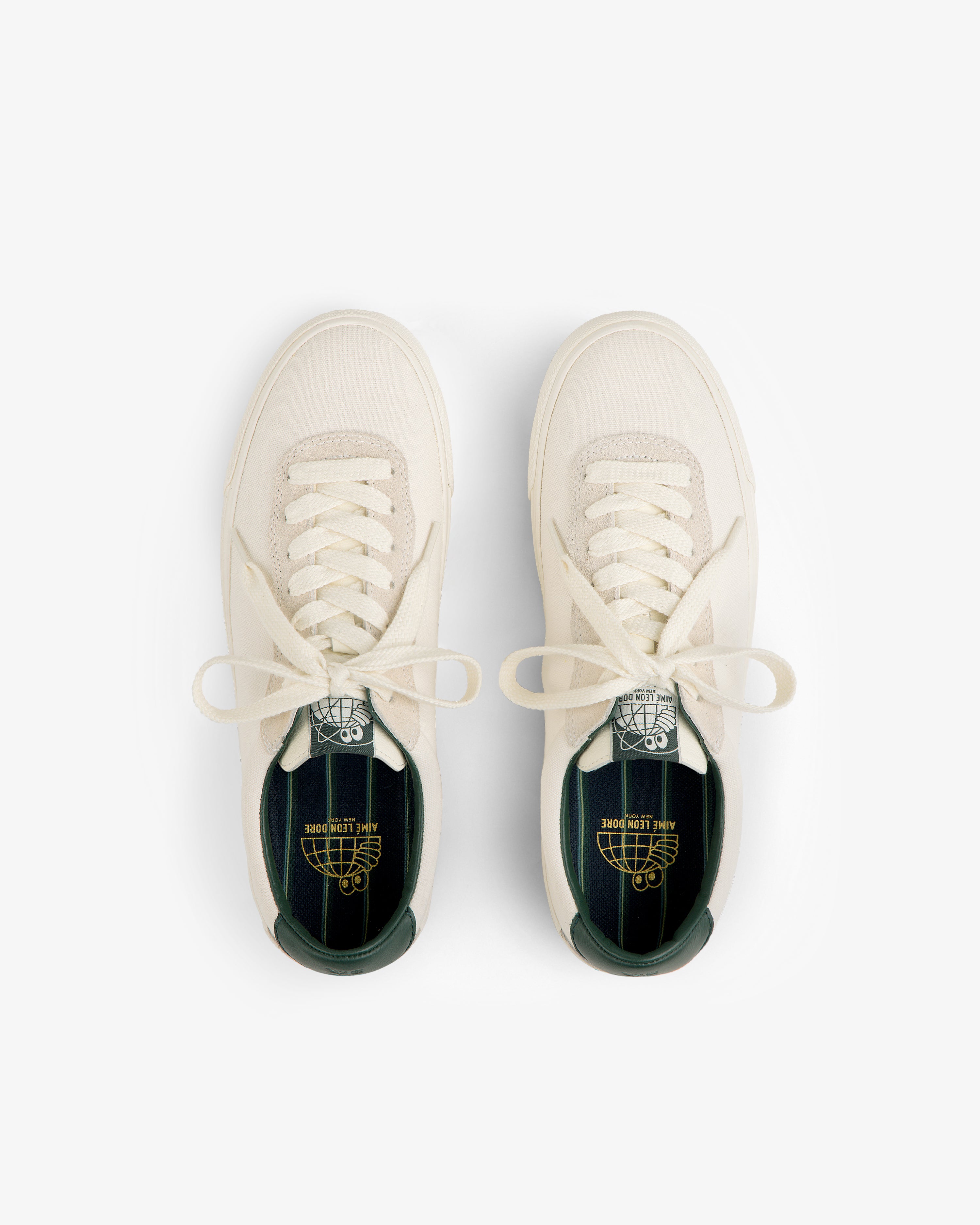 ALD / Last Resort AB VM001-LO Canvas cream sneakers with green insoles and branding, shown from above on white.