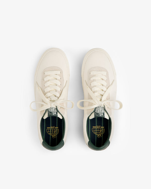 ALD / Last Resort AB VM001-LO Canvas cream sneakers with green insoles and branding, shown from above on white.