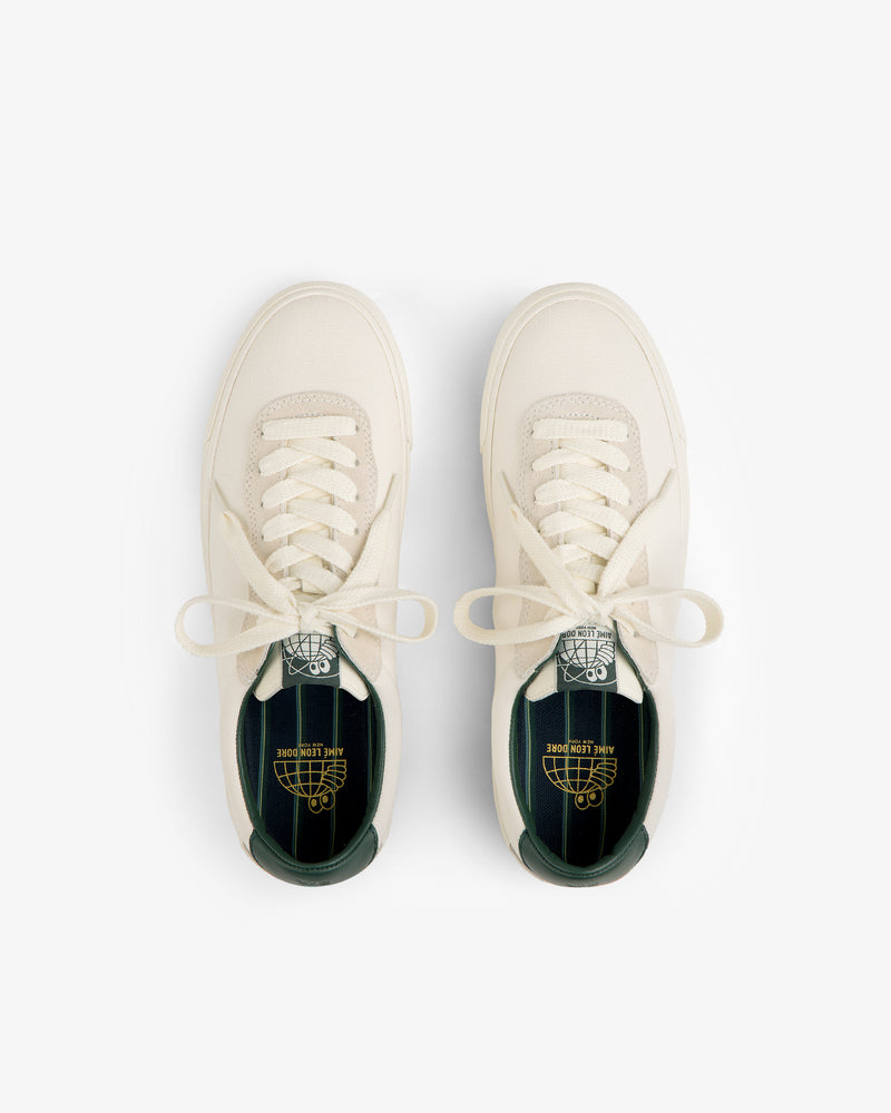 ALD / Last Resort AB VM001-LO Canvas cream sneakers with green insoles and branding, shown from above on white.