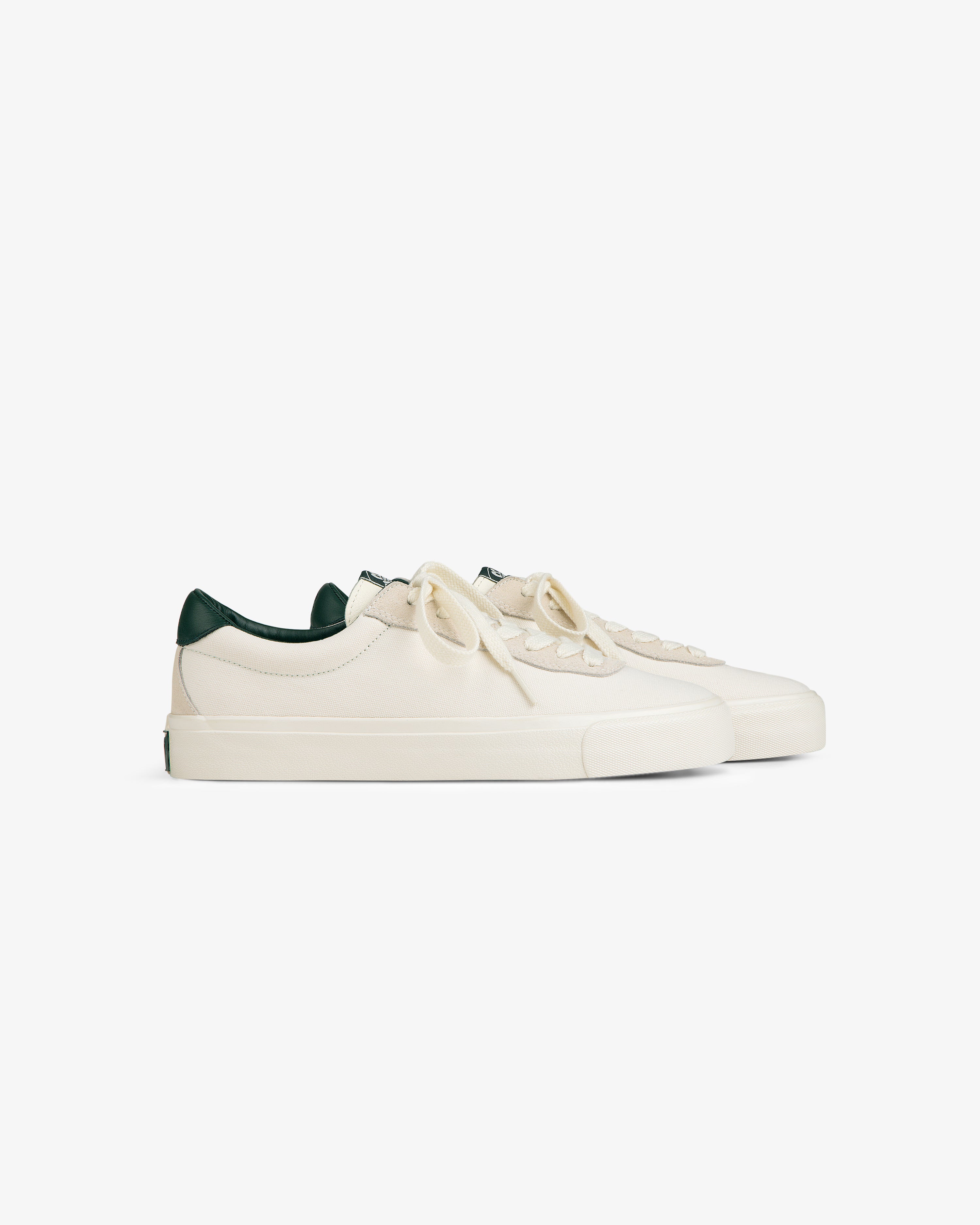 ALD / Last Resort AB VM001-LO Canvas off-white low-tops with green heel detail, displayed on white background.