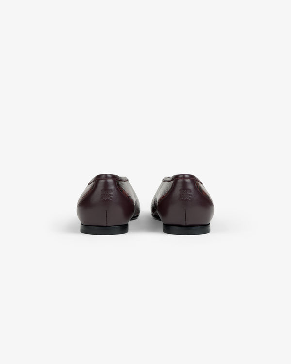 Back view of dark brown Snake Print Leather Ballet Flats with a textured finish.