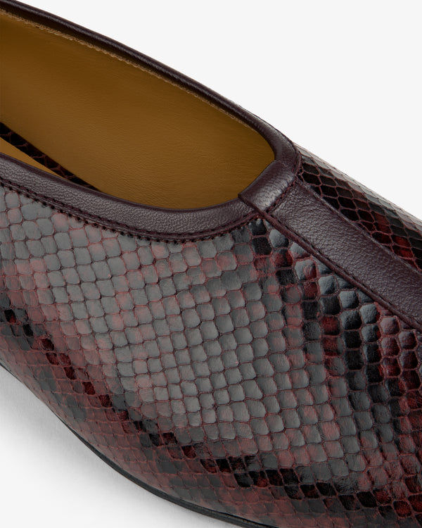 Close-up of a burgundy Snake Print Leather Ballet Flat.