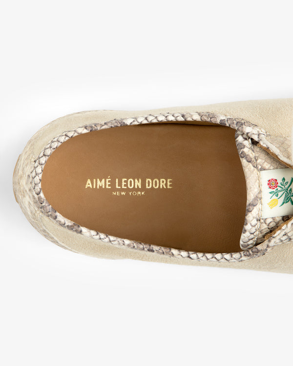 Top-down view of a Snake Print Low Profile Suede Trainer in beige with snakeskin trim and a gold-stamped insole logo.