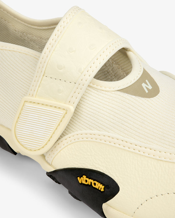 Cream-colored ALD / New Balance MT2 slip-on shoe with a velcro strap and a black Vibram rubber sole.