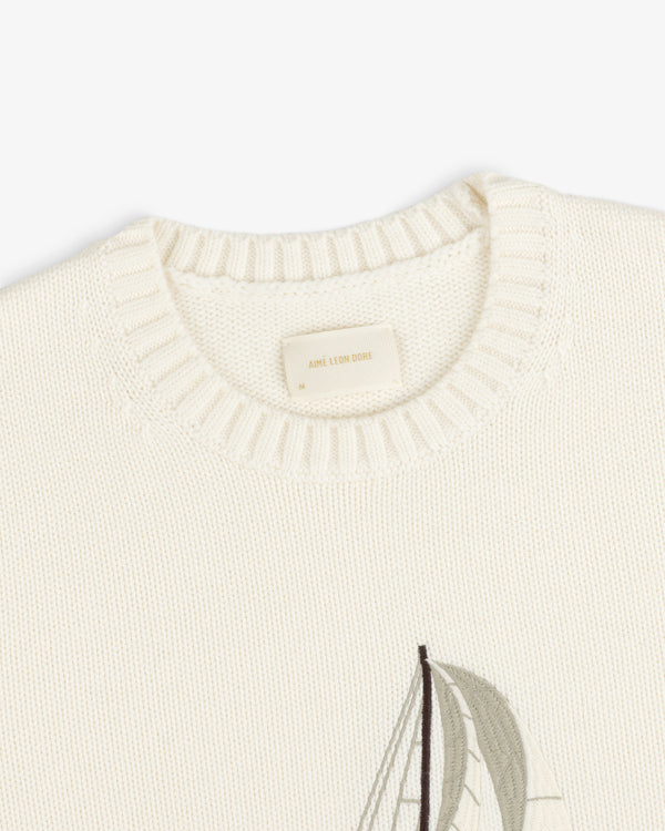 Regatta Embroidered Crewneck Sweater in cream with ribbed neckline and a partial sailboat design on the front.