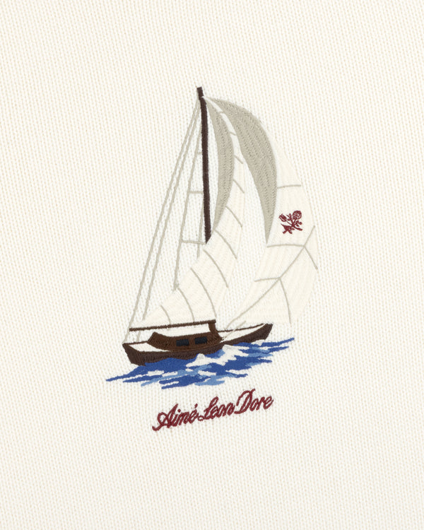 Regatta Embroidered Crewneck Sweater: Sailboat with white sails on blue water, Aimé Leon Dore text, cream fabric.