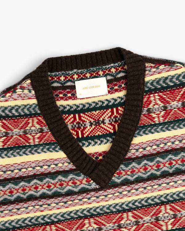 Fair Isle V-Neck Sweater with a brown collar features red, green, cream, and blue geometric knit patterns.