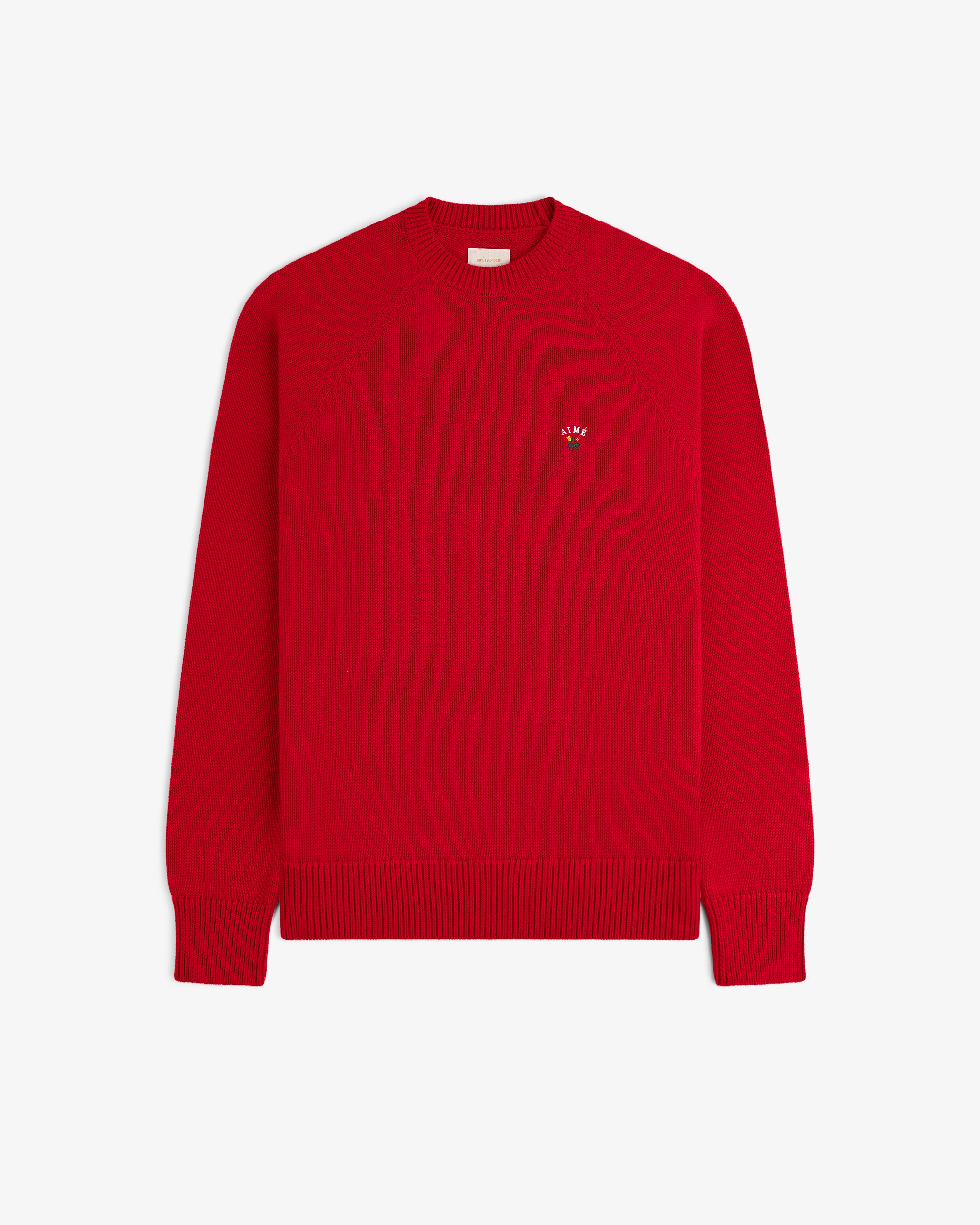 Crest Raglan Sweater: Plain red knit, long sleeves, small embroidered logo on left chest.