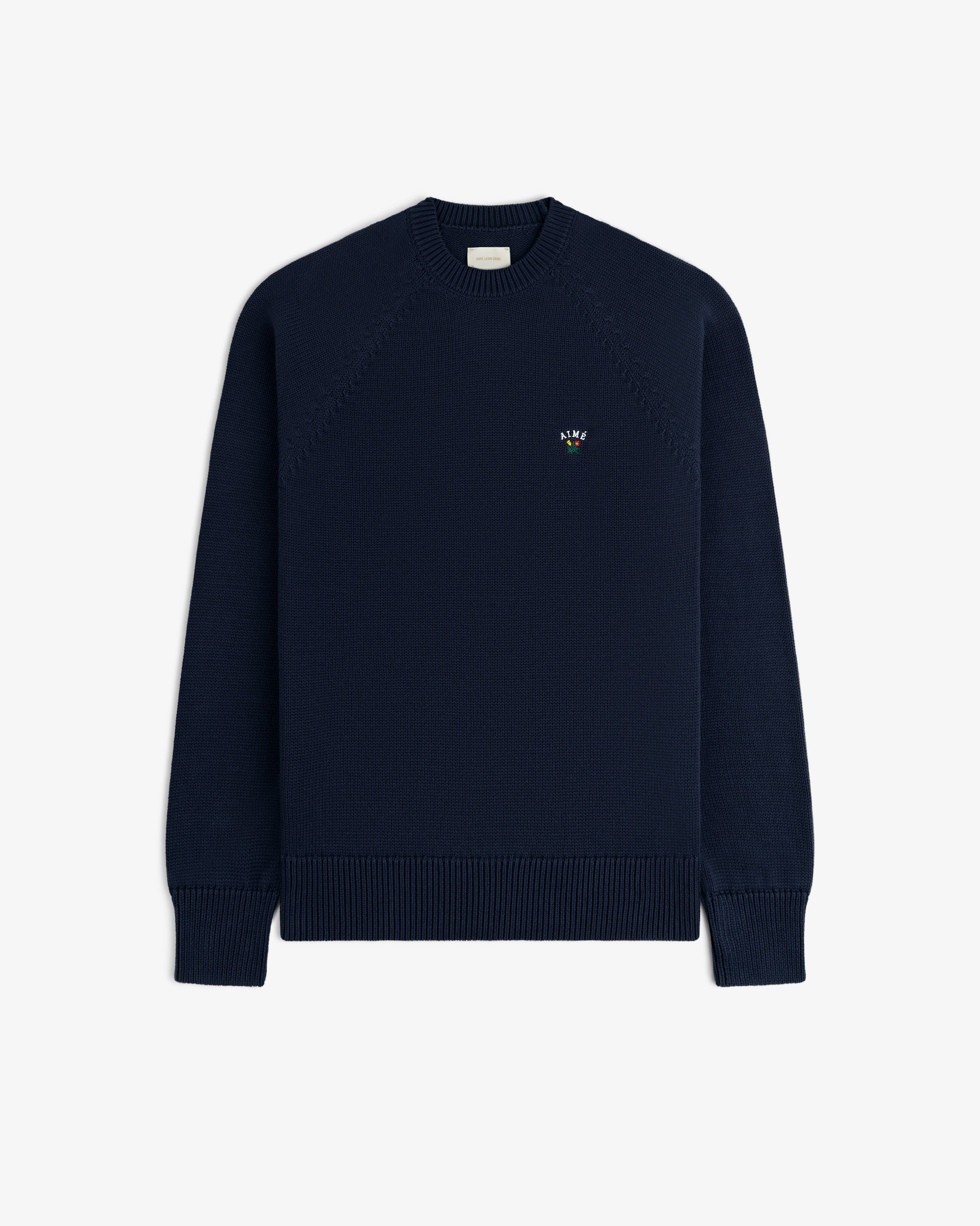 Crest Raglan Sweater in navy with small chest logo, crewneck style, shown on a plain white background.