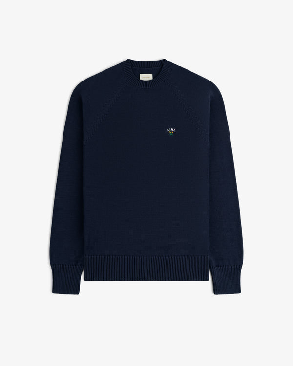 Crest Raglan Sweater in navy with small chest logo, crewneck style, shown on a plain white background.