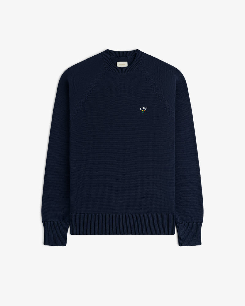 Crest Raglan Sweater in navy with small chest logo, crewneck style, shown on a plain white background.