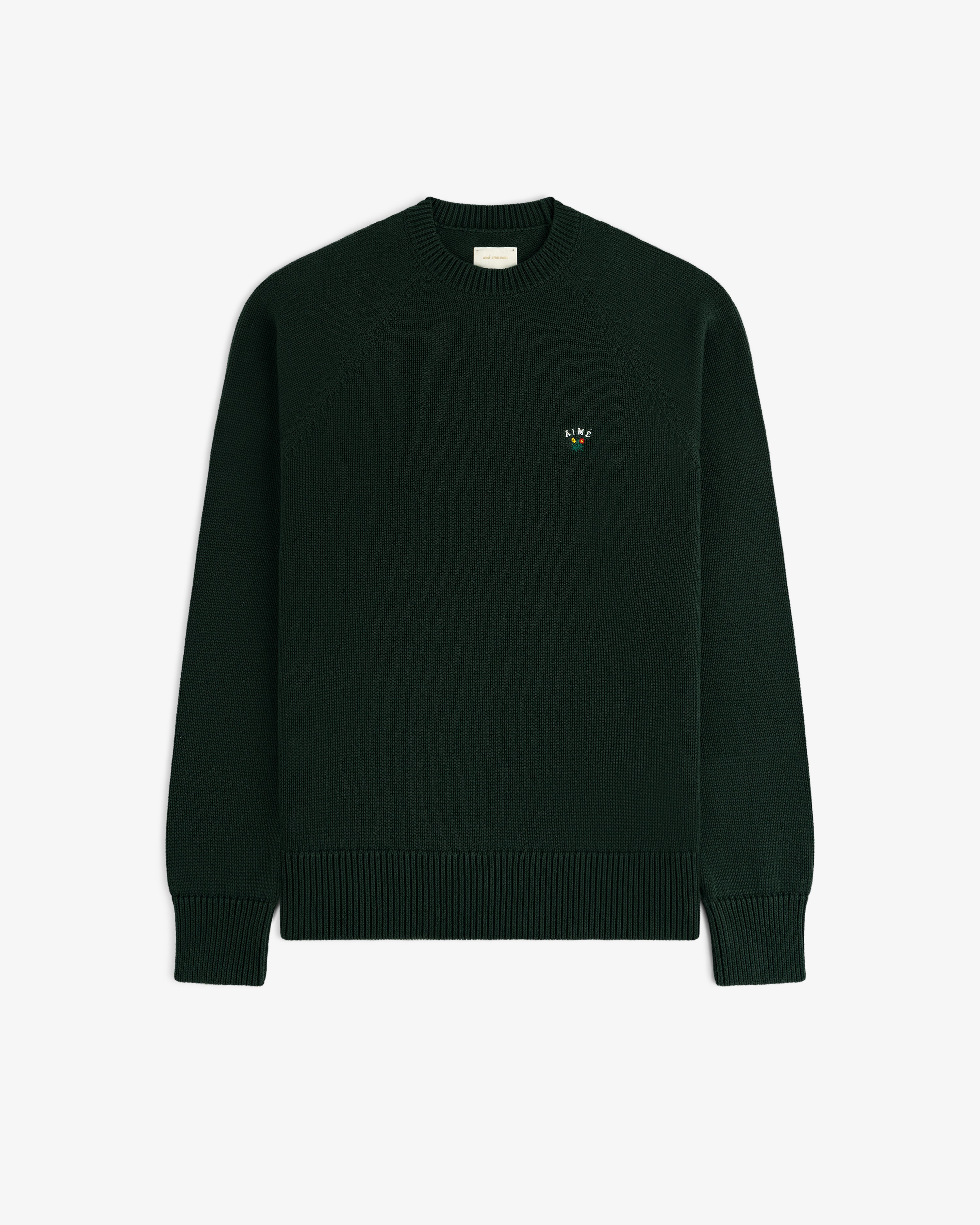 Crest Raglan Sweater: dark green knit with ribbed cuffs, hem, and a small colorful logo on the left chest.