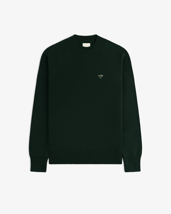 Crest Raglan Sweater: dark green knit with ribbed cuffs, hem, and a small colorful logo on the left chest.
