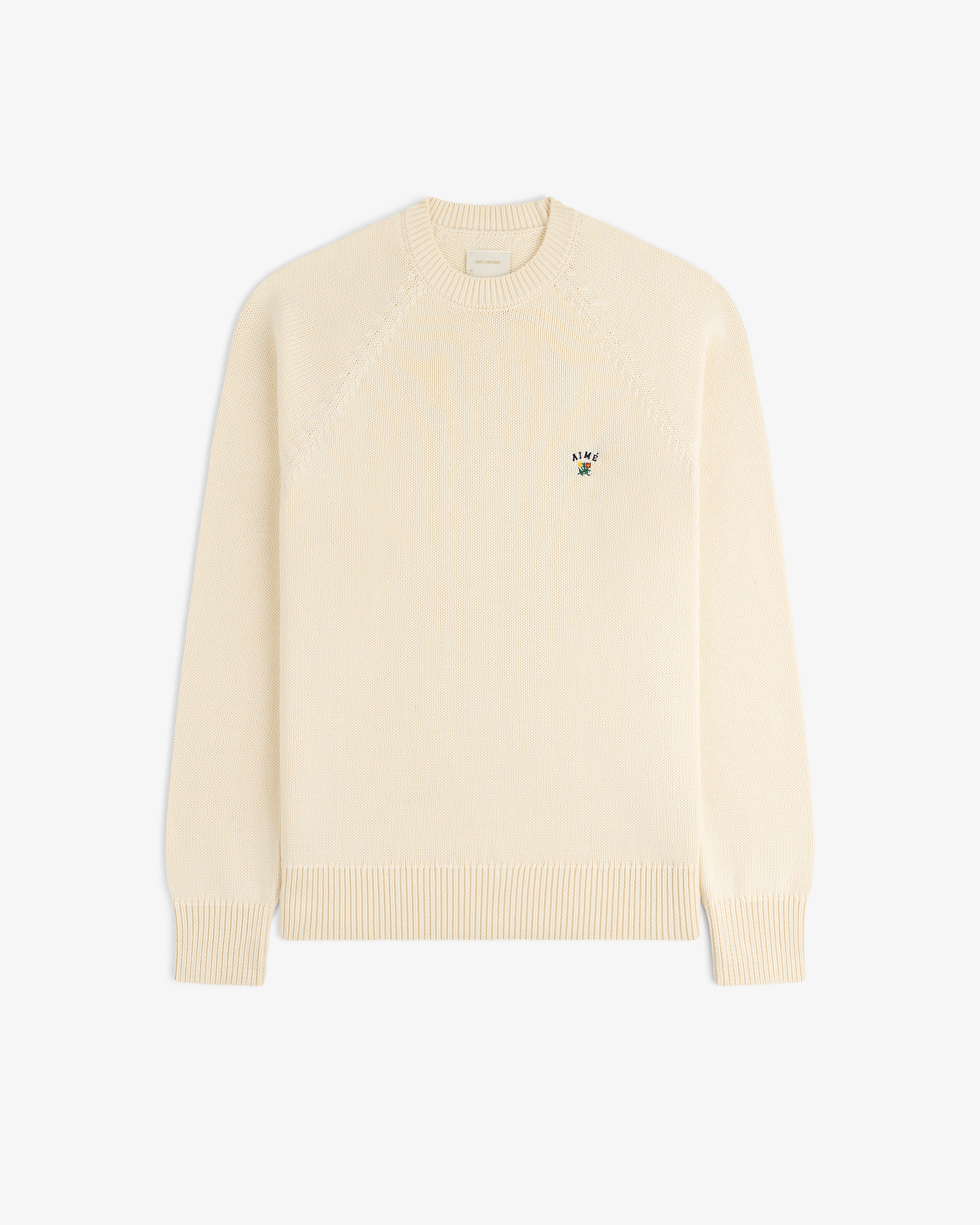 Crest Raglan Sweater: Cream knit, long sleeves, small embroidered logo on left chest.