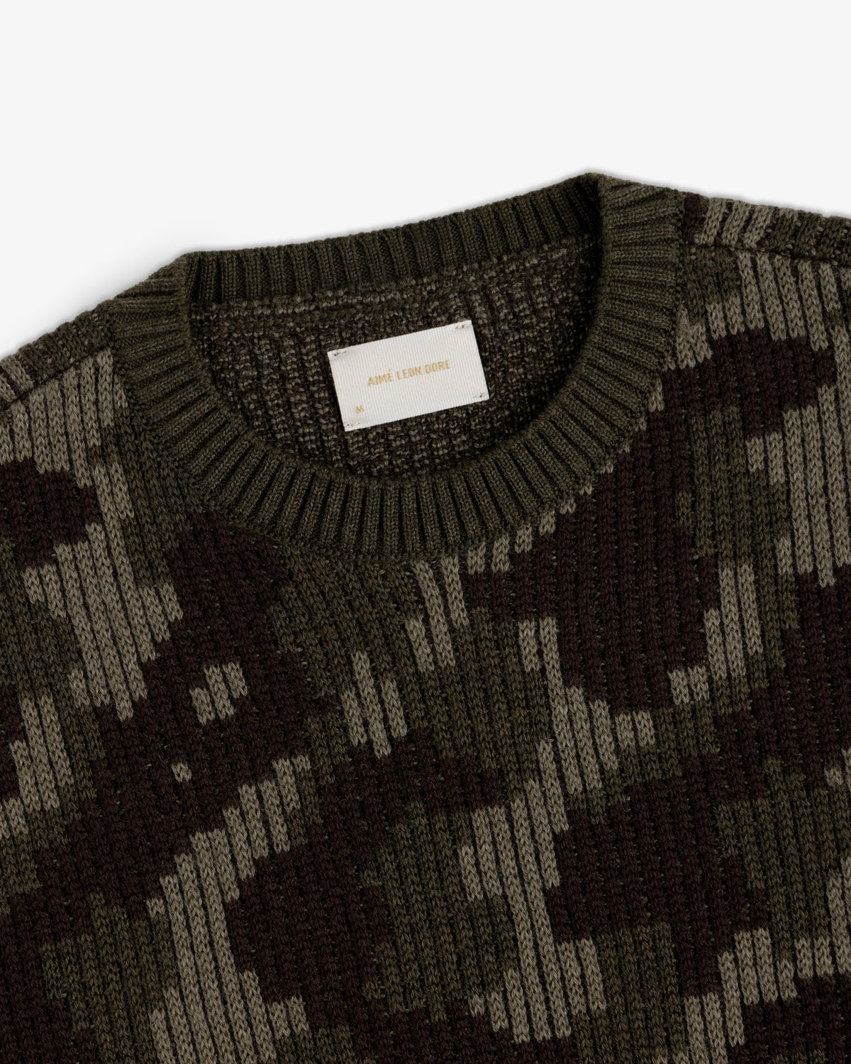 Wool Jacquard Camo Sweater featuring a dark green camouflage pattern and a crew neckline.