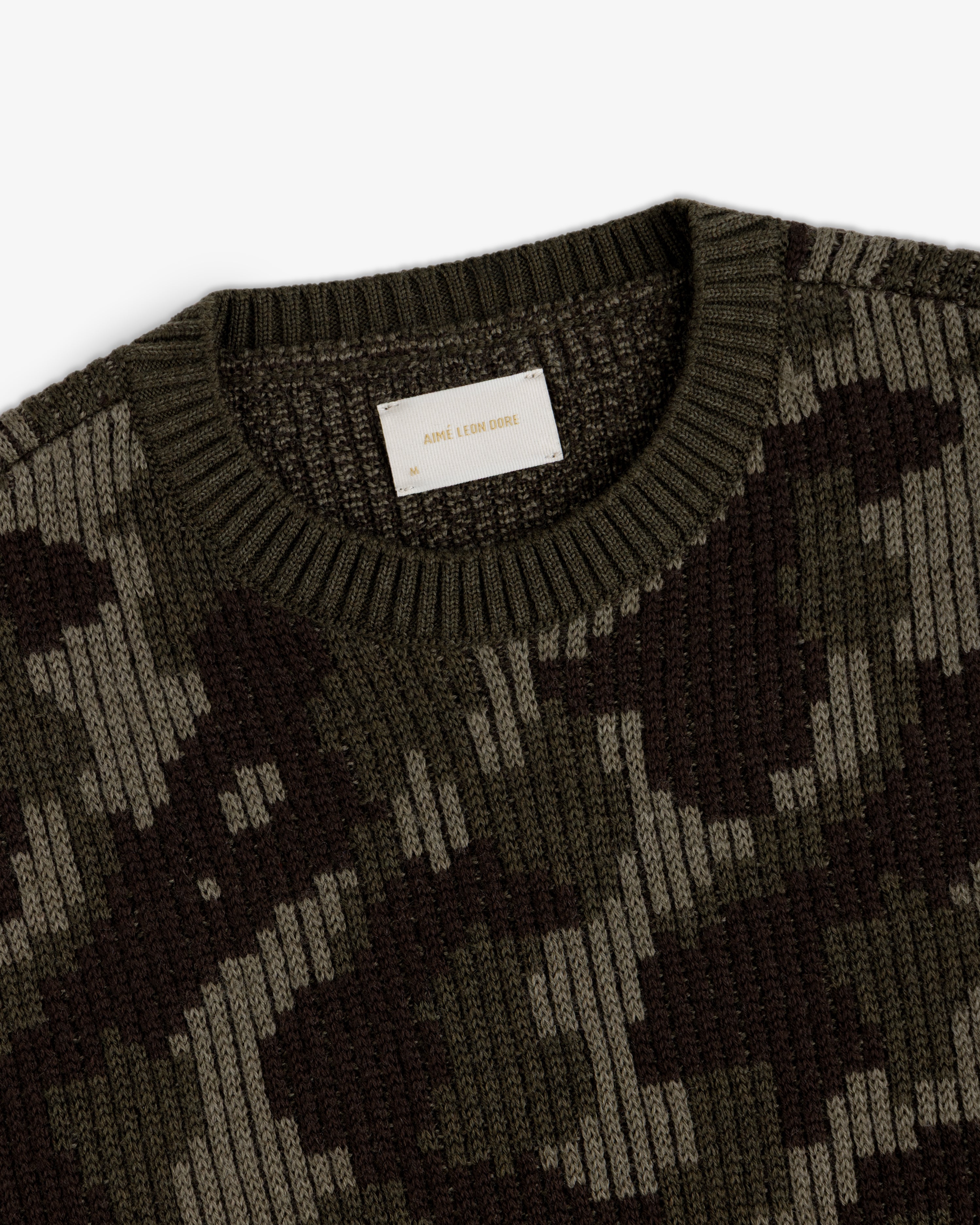 Wool Jacquard Camo Sweater featuring a dark green camouflage pattern and a crew neckline.