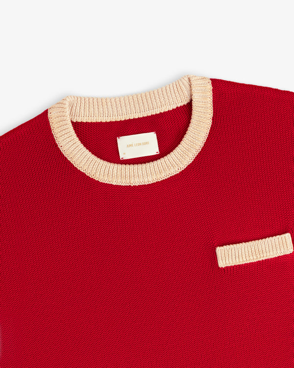 Knit Pocket Crewneck Sweater in red with a contrasting cream ribbed collar, chest pocket, and interior brand tag.