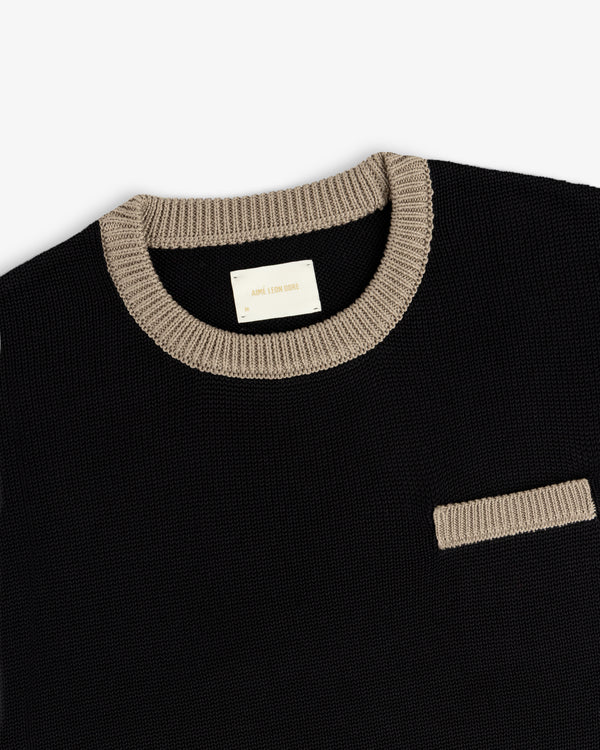 Knit Pocket Crewneck Sweater in black with a contrasting tan ribbed collar and chest pocket trim.