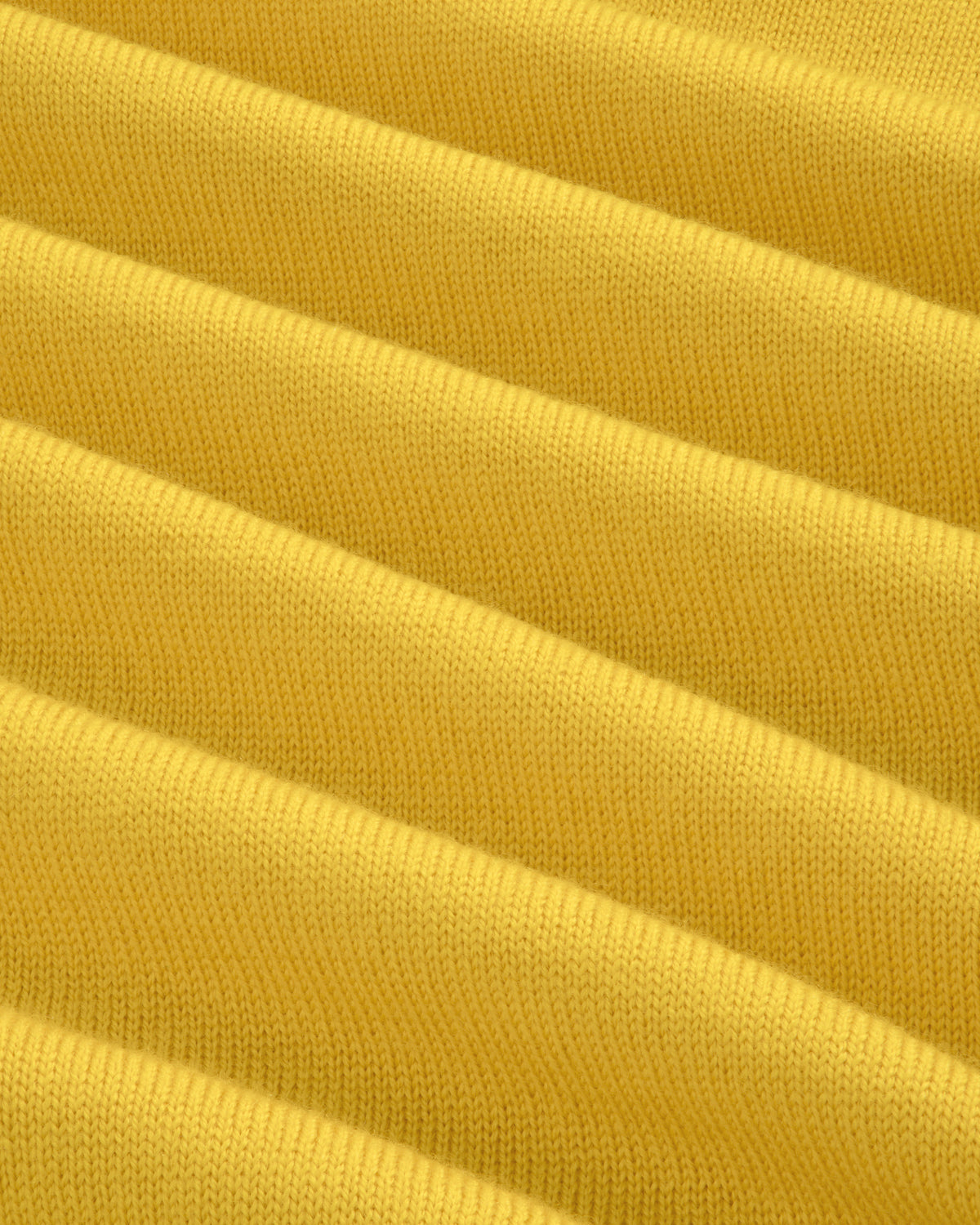 Close-up of yellow Merino Wool Knit Cycling Polo, showing ribbed texture and fine knit detail.