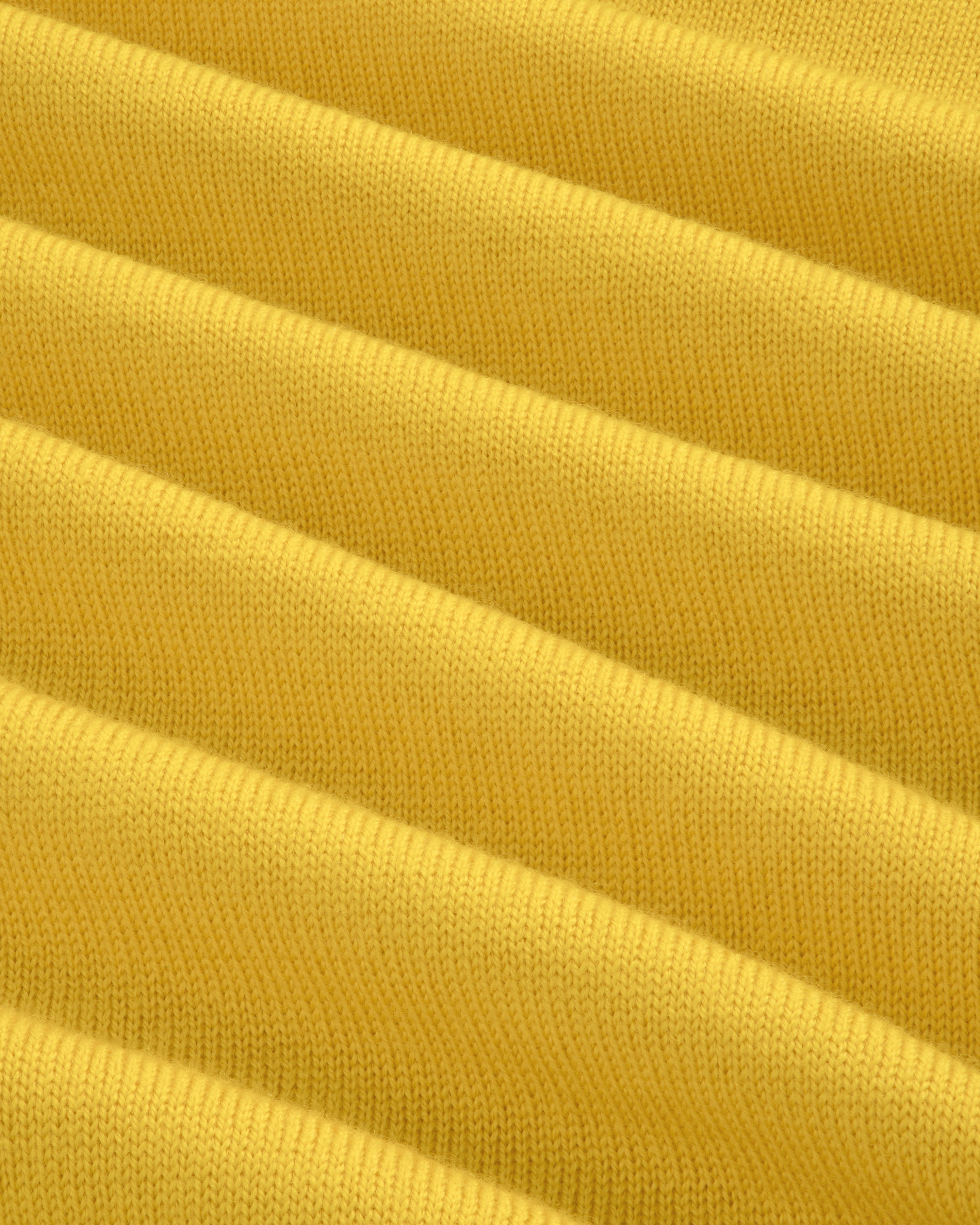 Close-up of yellow Merino Wool Knit Cycling Polo, showing ribbed texture and fine knit detail.