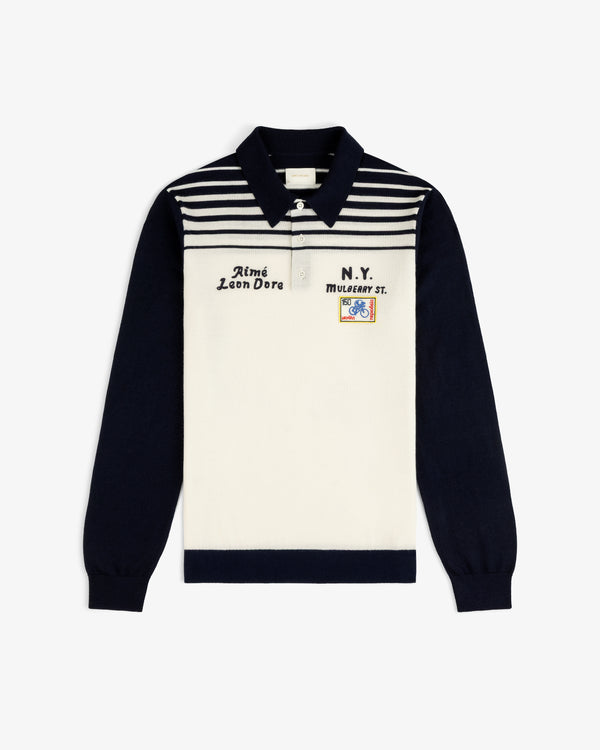 Merino Wool Knit Cycling Polo with navy sleeves, striped chest, and front embroidery and patches.