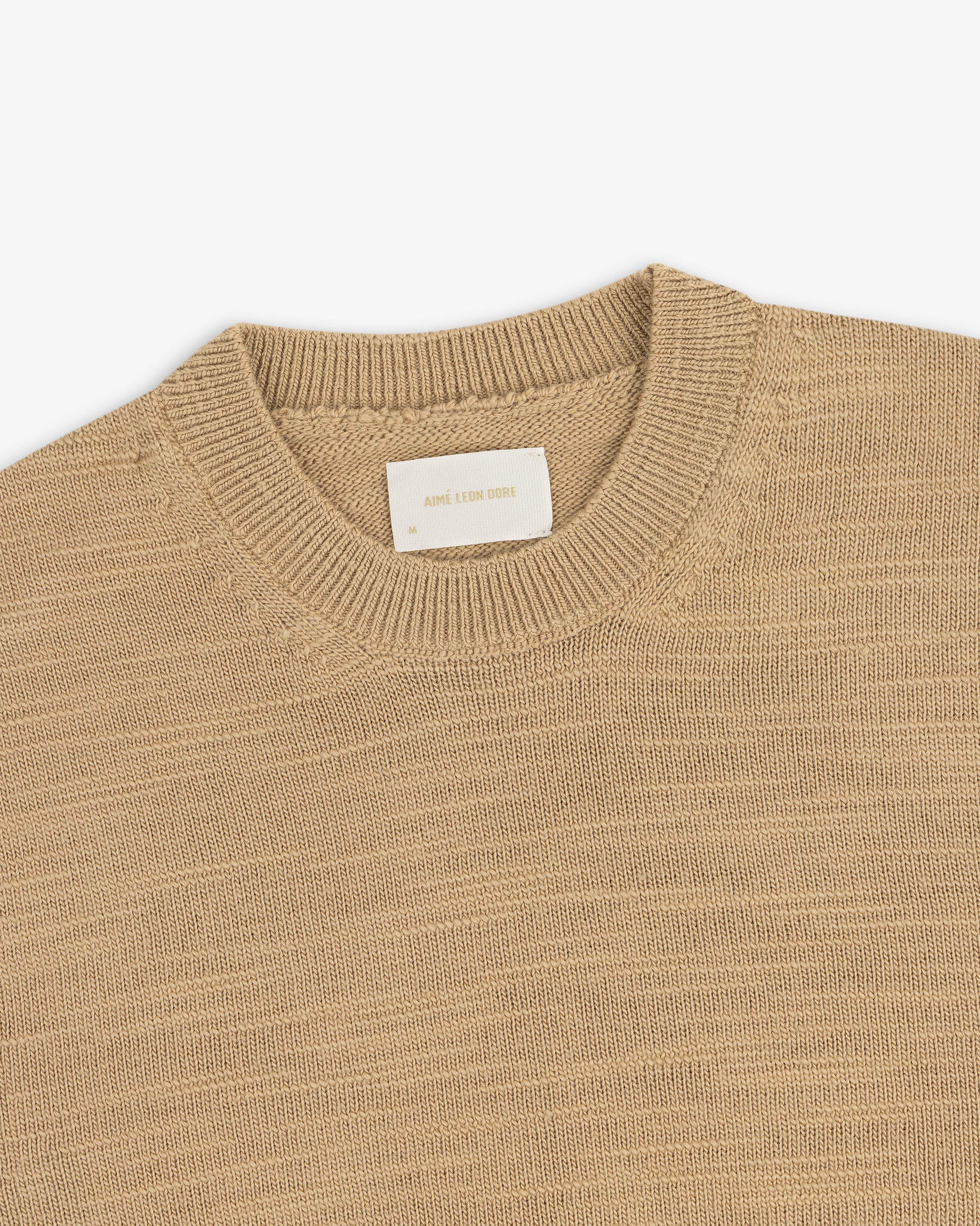 Tan Slub Merino Wool crewneck sweater with a textured knit and an interior brand label.