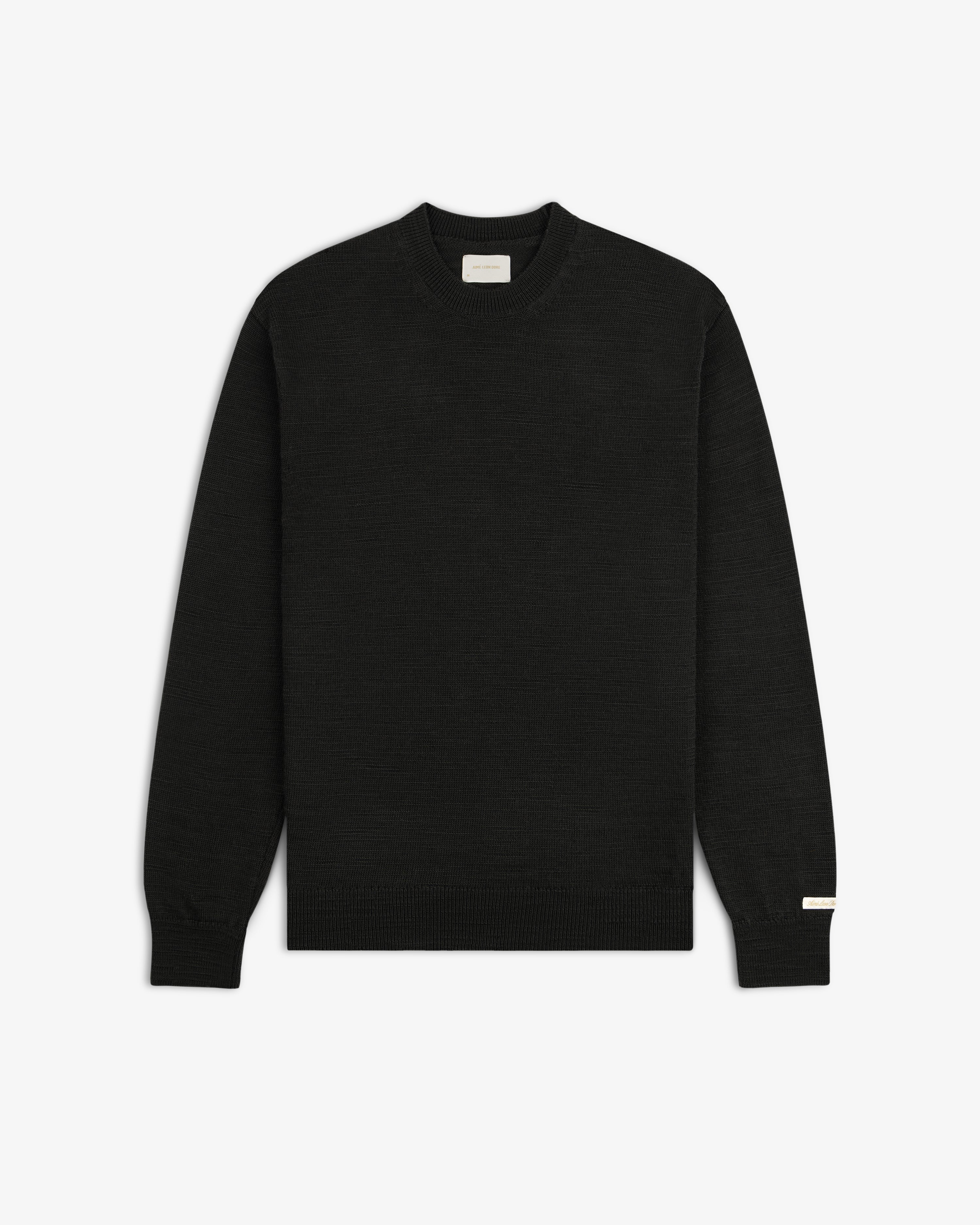 Black Slub Merino Wool long-sleeve crewneck sweater with a textured knit.