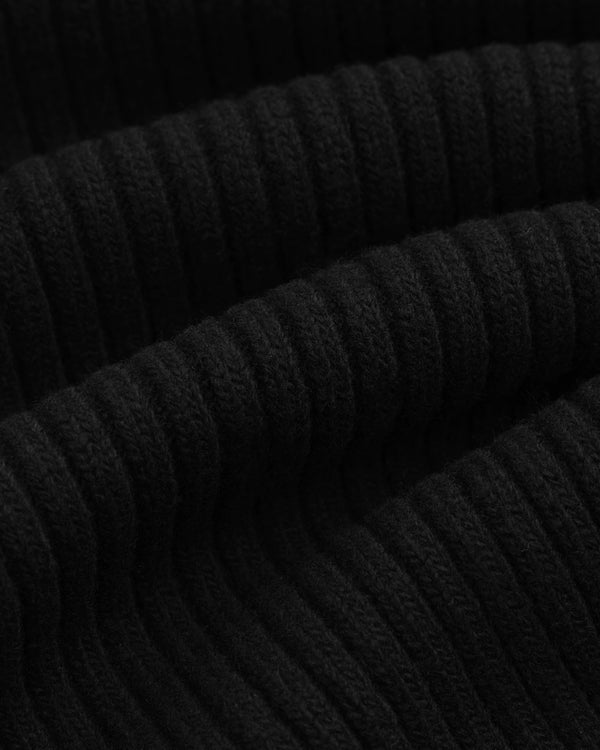 Close-up of the black ribbed knit fabric of a Wool Ribbed Knit Hoodie.
