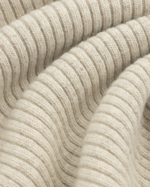 Close-up of beige Wool Ribbed Knit Hoodie fabric showing soft, ribbed folds.