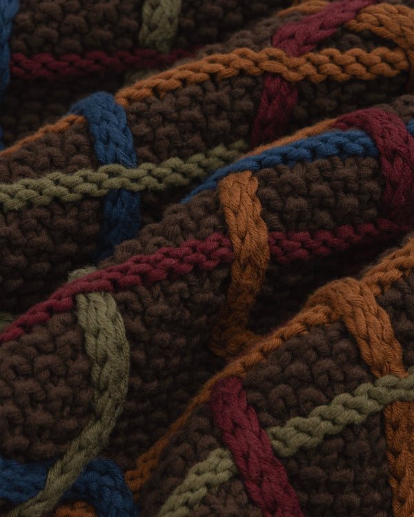 Close-up of a Cable Link Crewneck Sweater in brown with a raised cable pattern in blue, green, orange, and red.