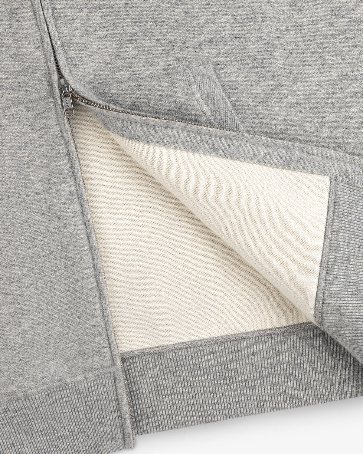 Close-up of the Full-Zip Pavilion Cashmere Hoodie, unzipped to reveal its soft off-white lining and detailed pocket.