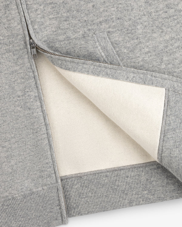 Close-up of the Full-Zip Pavilion Cashmere Hoodie, unzipped to reveal its soft off-white lining and detailed pocket.
