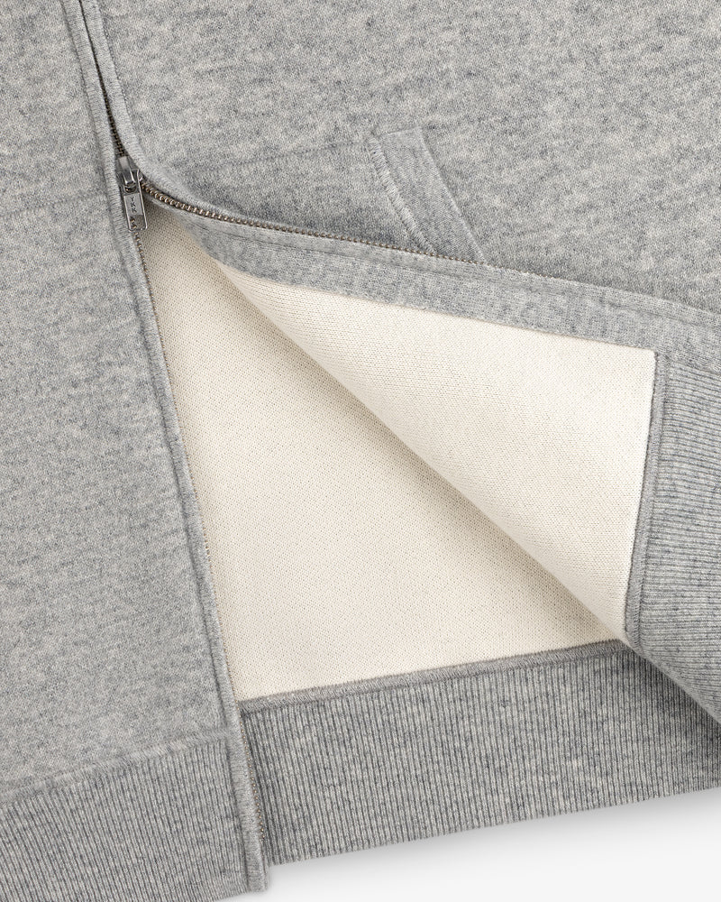 Close-up of the Full-Zip Pavilion Cashmere Hoodie, unzipped to reveal its soft off-white lining and detailed pocket.